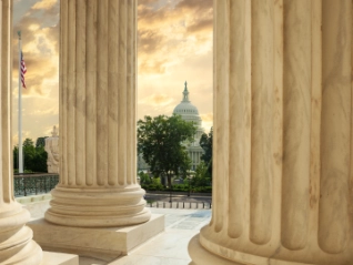 capitol building through columns of supreme court
