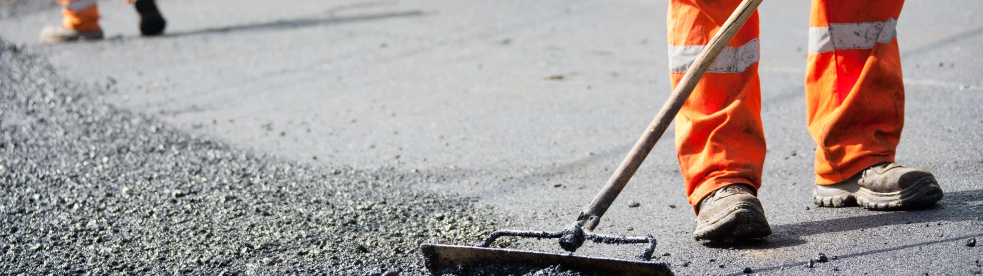 construction workers laying tarmacadam roads